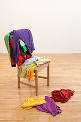 Image showing Colorful messy clothes on a chair