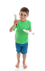 Image showing Standing boy holding paints and brushes