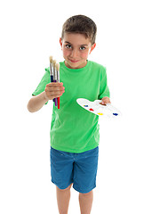 Image showing Young boy artist holding paints and brushes