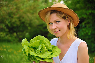 Image showing Young woman holding fresh lettuce