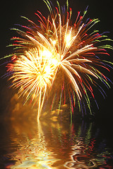 Image showing A beautiful fireworks display is captured in Connecticut with billowing smoke and water reflections.