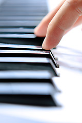 Image showing Close up of the hands of a young man playing piano 