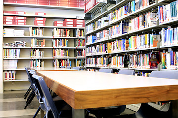 Image showing library stacks of books with table 