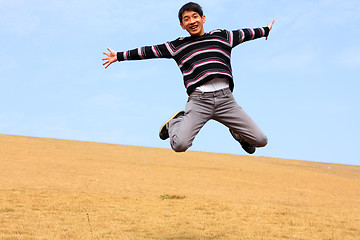 Image showing Happy jumping man on winter day 