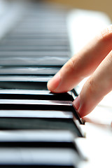 Image showing Close up of the hands of a young man playing piano 