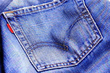 Image showing Fragment of blue modern jeans with pocket, can be used as a back