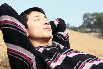 Image showing Man lying in yellow grass