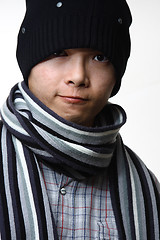 Image showing A happy smiling man wearing a hat and scarf posing against white