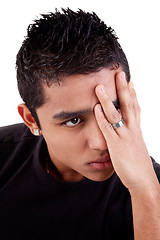 Image showing young latin man, pensive, with his hand on front of eyes