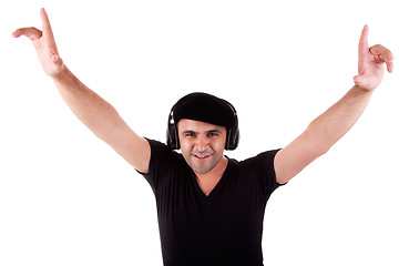 Image showing man listening music in headphones, arms raised