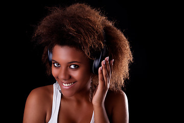 Image showing Beautiful black woman happy listening music in headphones