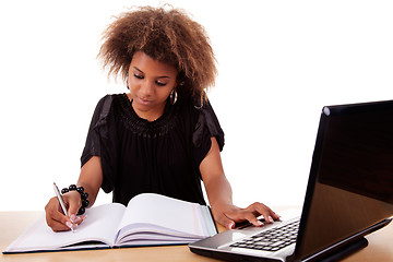 Image showing young black women working on desk with computer