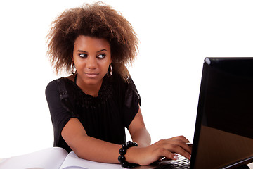 Image showing young black women working on desk looking to computer