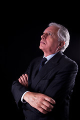 Image showing Portrait of a handsome mature businessman, looking up thinking,