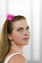 Image showing young woman with flower in her hair