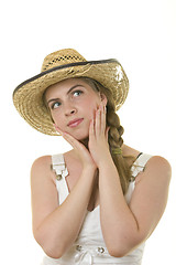 Image showing Girl in worn straw  hat