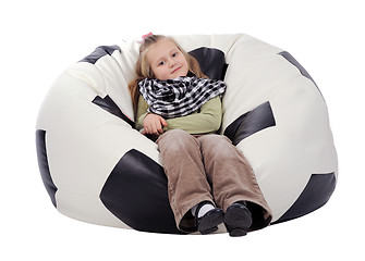 Image showing Girl sitting on an inflatable chair in the form of a soccer ball