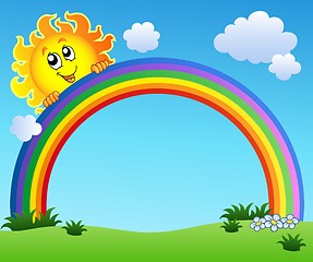 Image showing Sun holding rainbow on blue sky