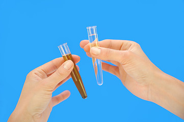 Image showing Clean and dirty water samples in hands