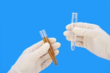 Image showing Clean and dirty water samples in hands