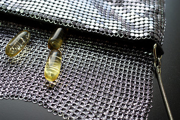 Image showing Fish Oil Capsules in Evening Bag