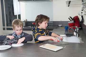 Image showing Two boys doing the dishes