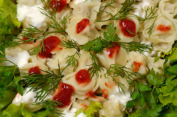 Image showing Ravioli with greens sour cream and ketchup dish