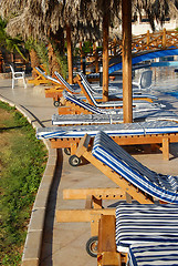 Image showing Folding chairs row by swimming pool