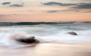 Image showing water on rocks at sunset