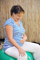 Image showing Pregnant young woman exercising with ball