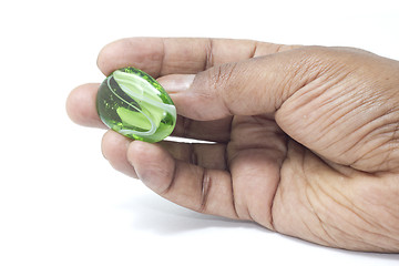 Image showing Hand holding a beautiful green marble