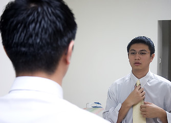 Image showing Young Asian Man Preparing to Work