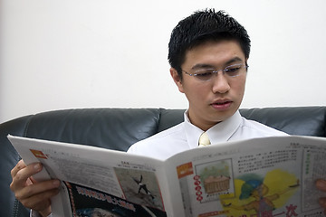 Image showing Young Asian Entrepreneur Reading Newspaper