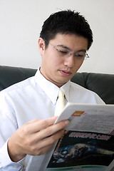 Image showing Young Asian Entrepreneur Reading Newspaper