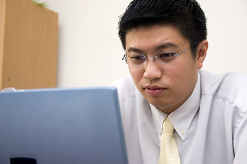 Image showing Young Asian Entrepreneur Working with Computer