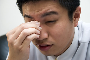 Image showing Tired Young Asian Entrepreneur