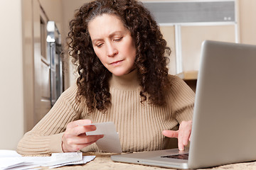 Image showing Woman paying bills