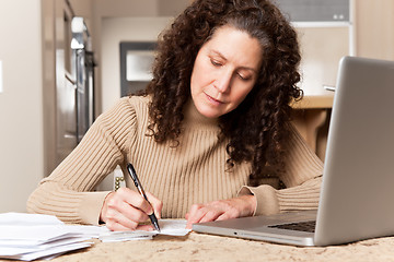 Image showing Woman paying bills