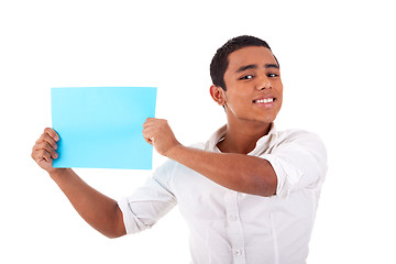 Image showing young latin man, with blue  card in hand, smiling