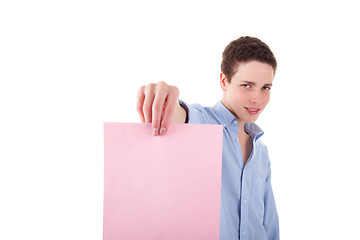 Image showing young smiling man holding a pink sheet of paper in his hand