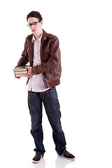 Image showing young and handsome young man, with books on the hands