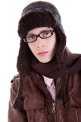 Image showing Young boy looking serious, with winter clothes, glasses and hat