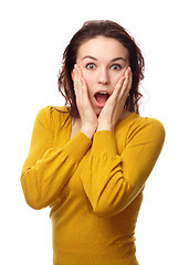 Image showing Girl holding her face in astonishment