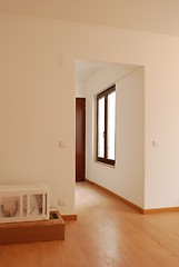 Image showing Empty living room with wooden floor and some boxes