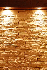 Image showing Unshaped stone wall with spot lights
