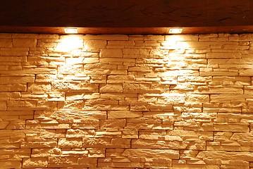 Image showing Unshaped stone wall with spot lights