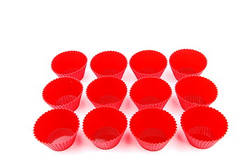 Image showing Red plastic cups for small cakes on white