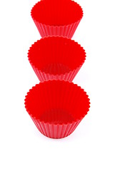 Image showing Red plastic cups for small cakes on white