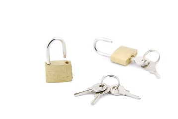 Image showing Two golden open padlock with keys on white