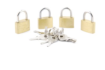 Image showing Golden closed padlocks with keys on white